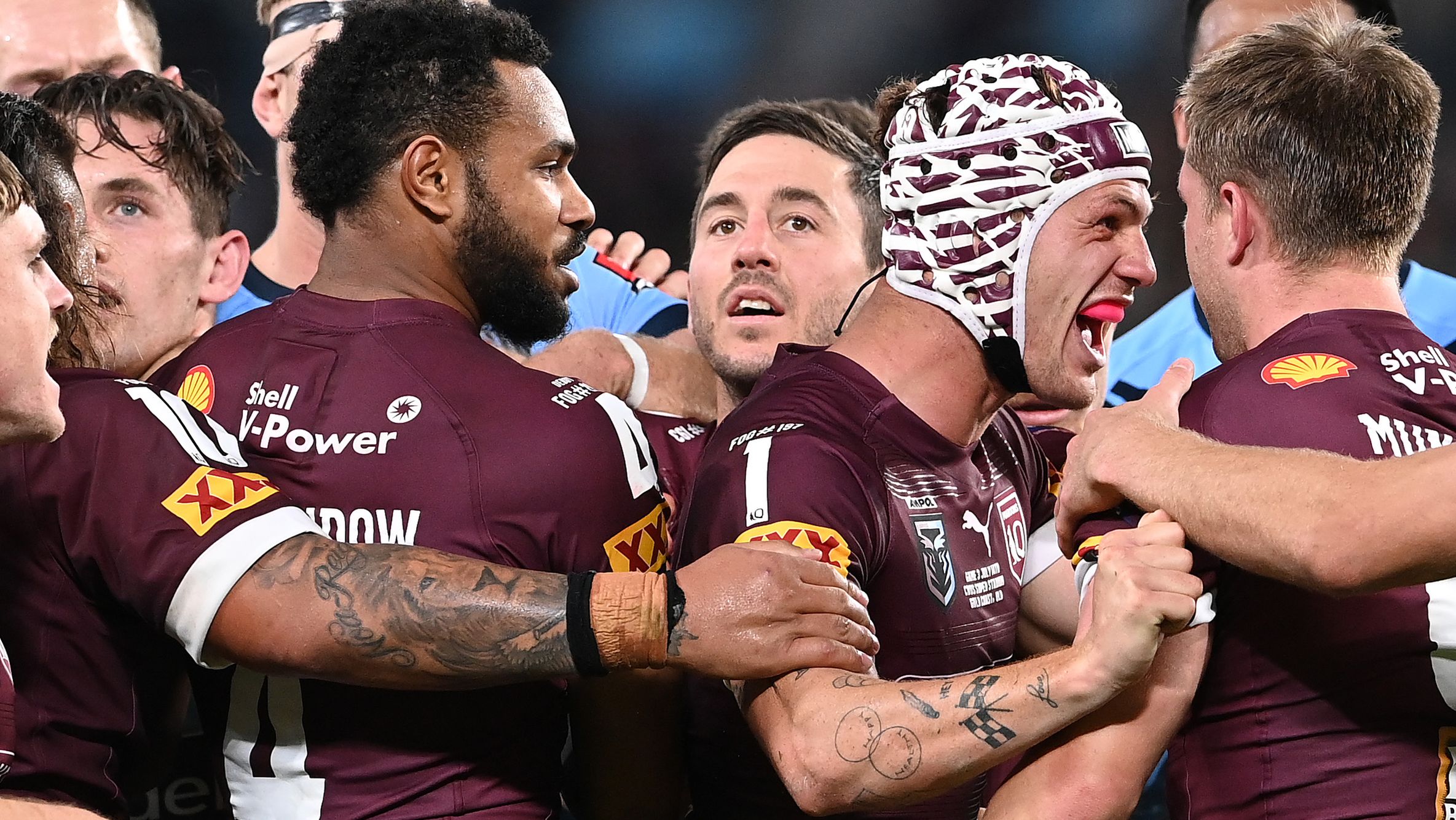 Maroons players celebrate a try during the 2021 Origin series.