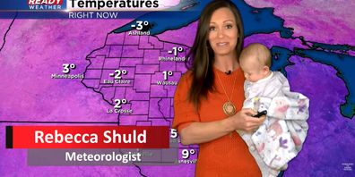 Meteorologist from the US does live cross with baby in hand. 