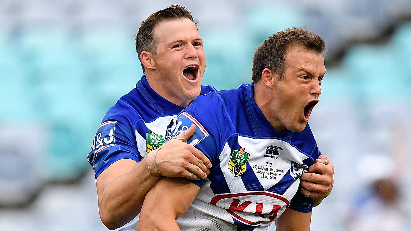 Josh Morris of the Bulldogs (right) celebrates with brother Brett (left) after scoring a try