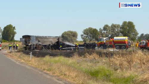 Fire crews remain at the scene to extinguish flames from the crash. (9NEWS)