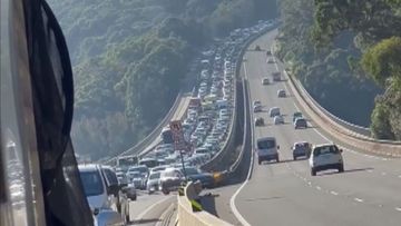 Commuters are experiencing up to an hour and 40 minutes of traffic delays after a man died by crashing his ute in a high-speed police chase in Menai.