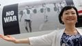 'Napalm Girl' escorts refugees fleeing war
