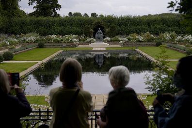 People look at a recently unveiled statue of Diana, Princess of Wales, in the Sunken Garden at Kensington Palace in London, Tuesday, Aug. 31, 2021, on the 24th anniversary of the death of Princess Diana.