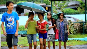 Residents evacuate to the Central Elementary School which was turned into an evacuation centre in Santo Domingo, Albay province on December 25, 2016 due to approaching Typhoon Nock-Ten. (AFP)