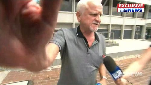 The man hurled abuse and threw punches at the camera crew. (9NEWS)