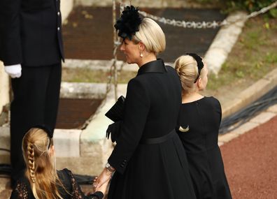 Zara Tindall, Lena Tindall, and Mia Tindall arrive at Windsor Castle for the Committal Service for Queen Elizabeth II on September 19, 2022 in Windsor, England.  