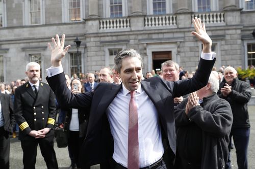 The new Prime Minister of Ireland, Simon Harris gestures as he is applauded by fellow lawmakers outside Leinster House in Dublin, Ireland, Tuesday, April 9, 2024.  