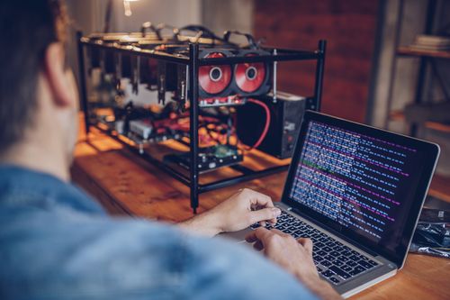 One man, sitting in his office, using computer for mining bitcoin. cryptocurrency crypto