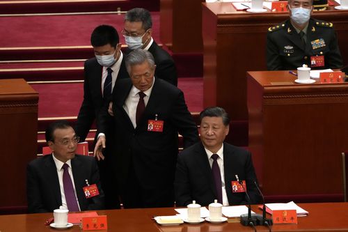 Former President Hu Jintao walks past Chinese President Xi Jinping, right, and Premier Li Keqiang during the closing ceremony of the 20th National Congress of China's ruling Communist Party at the Great Hall of the People in Beijing, Saturday, Oct. 22, 2022.