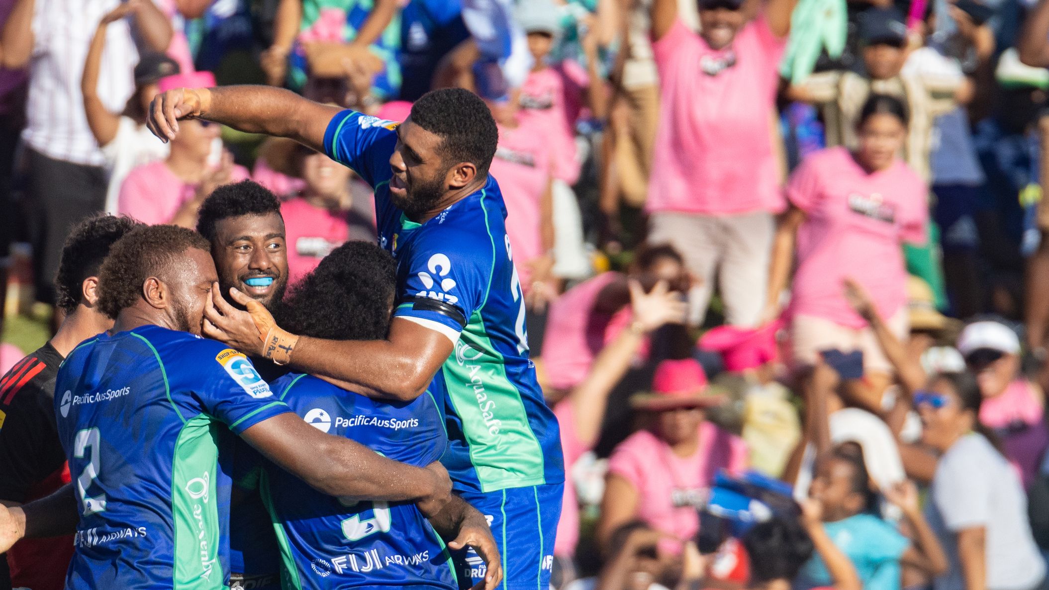 Fijian Drua celebrate a try.