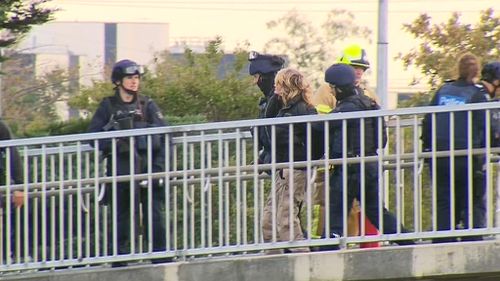 A woman in her 50s has been arrested after staging a protest over the Monash Freeway. (9NEWS)