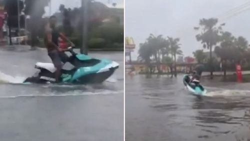 A man has been seen riding a jet ski through floodwaters in NSW.