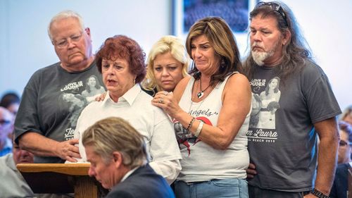 Hattie Stretz, second from left, a survivor of the Salon Meritage hair salon shooting in 2011, is comforted by Bethany Webb, the sister of Laura Webb Elody, one of eight people killed, and family as she speaks to Scott Dekraai during a victim impact statement in Superior Court in Santa Ana. (Image: AP)