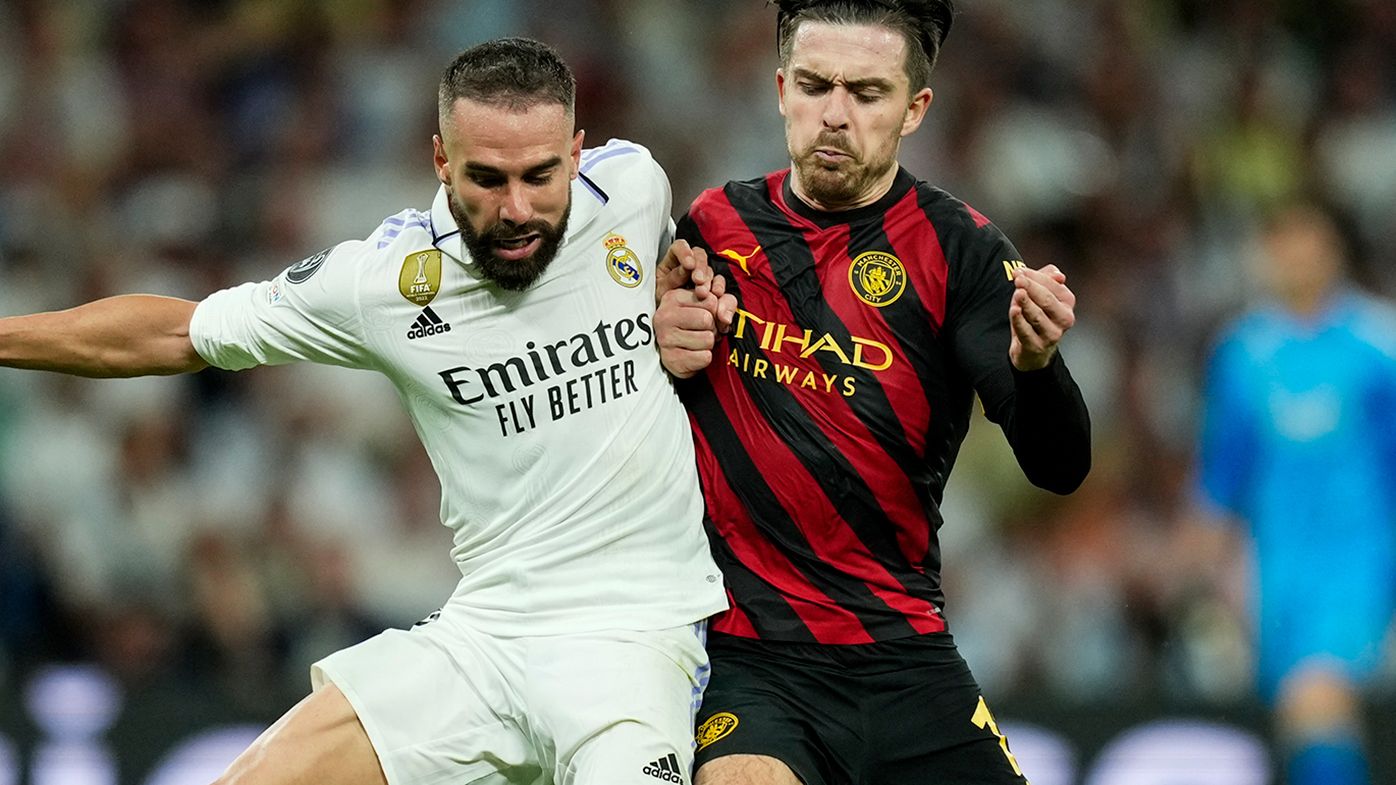 Real Madrid&#x27;s Dani Carvajal, left, duels for the ball with Manchester City&#x27;s Jack Grealish.