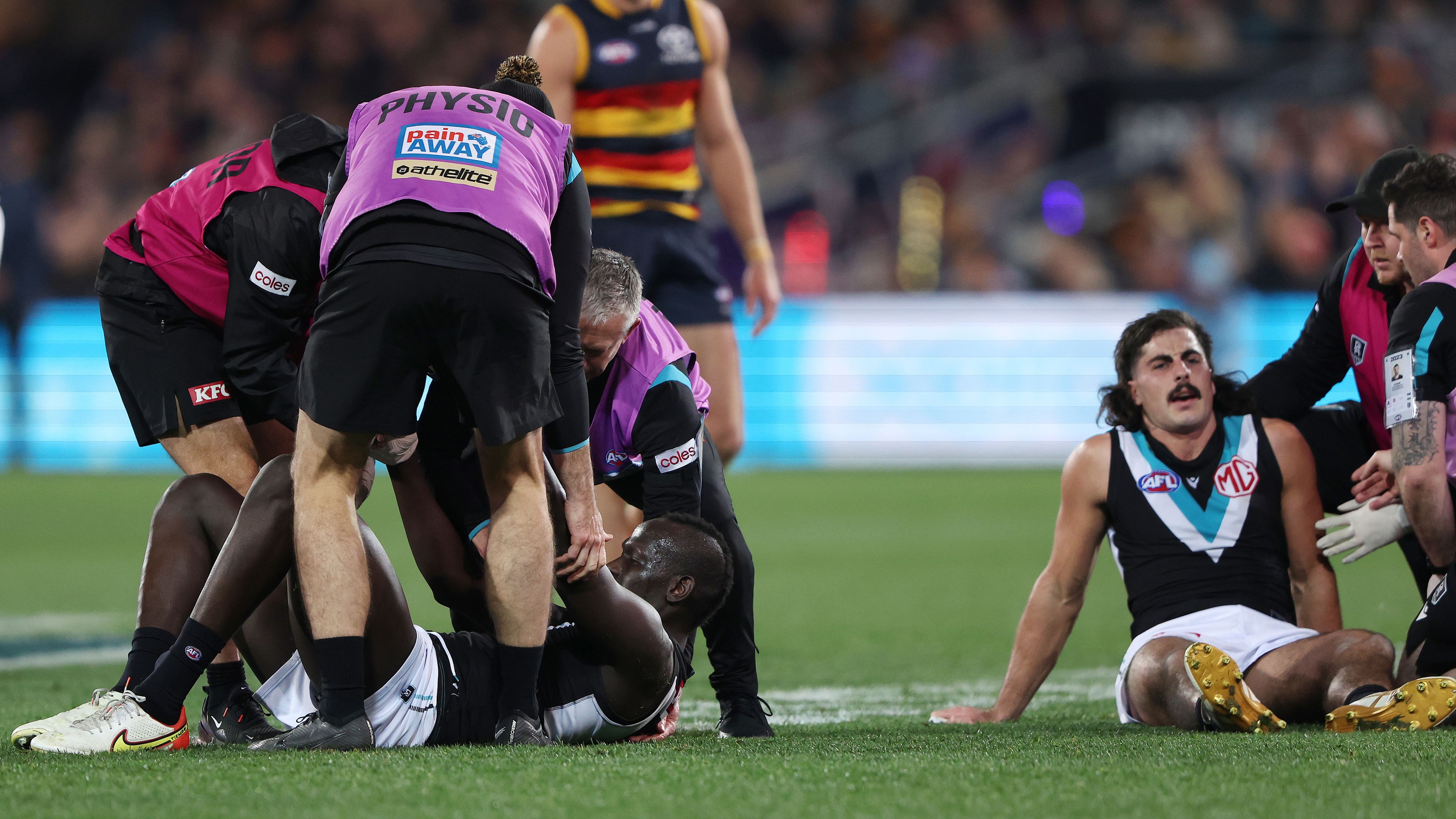ADELAIDE, AUSTRALIA - JULY 29: Aliir Aliir of the Power down after a collision with Lachie Jones of the Power during the 2023 AFL Round 20 match between the Adelaide Crows and the Port Adelaide Power at Adelaide Oval on July 29, 2023 in Adelaide, Australia. (Photo by Sarah Reed/AFL Photos via Getty Images)