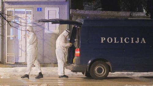 Police investigators work at the site of a shooting in Cetinje, 36 kilometers (22 miles) west of Podogrica, Montenegro, Wednesday, Jan 1, 2025. (AP Photo/Risto Bozovic)