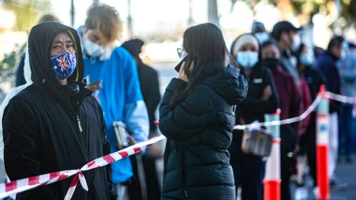 People queue for the COVID-19 vaccine at the Sunshine Hospital vaccination hub, in Victoria.