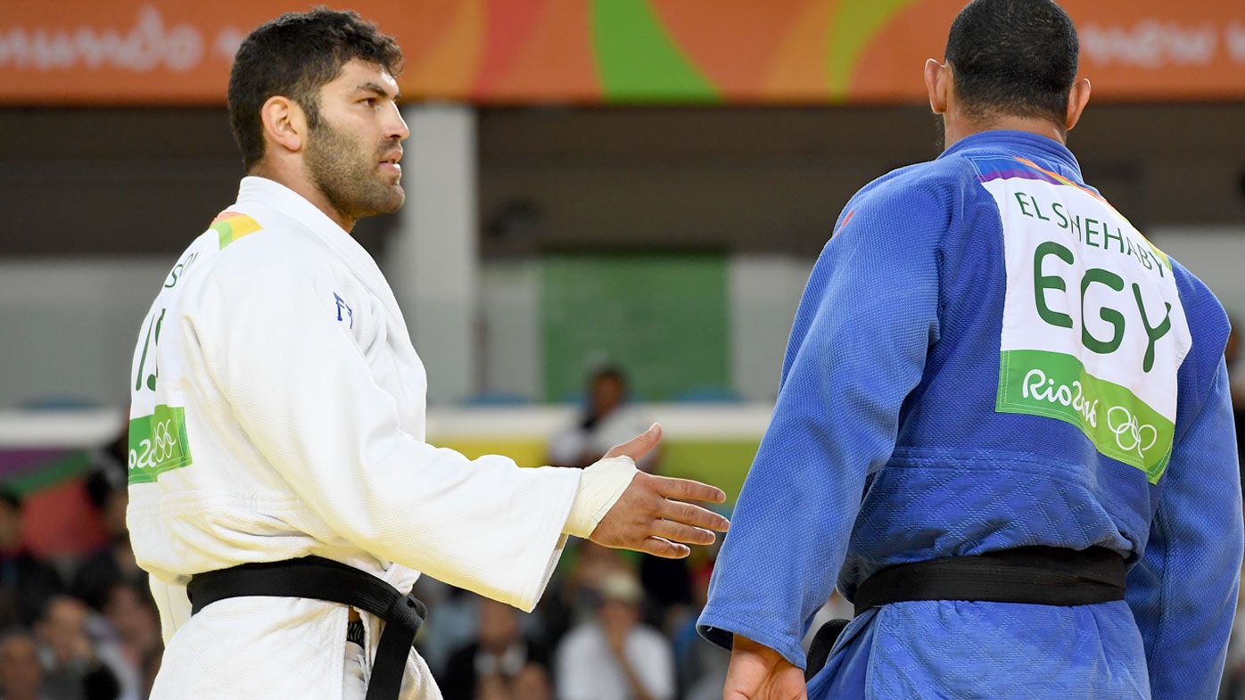 Israel's Or Sasson (white) competes with Egypt's Islam Elshehaby during their men's +100kg judo contest match of the Rio 2016 Olympic Games. (AFP)
