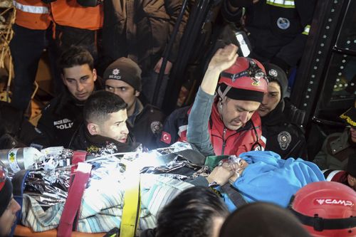 Rescuers surround Hatice after she was rescued 92 hours after Monay's earthquake in Kahramanmaras, southern Turkey, early Friday, Feb. 10, 2023. 