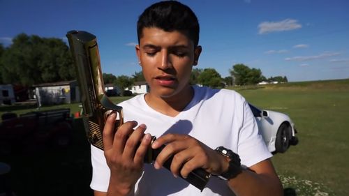 Pedro Ruiz, 22, shows off the .50-caliber Desert Eagle handgun he plans to use in the stunt. 
