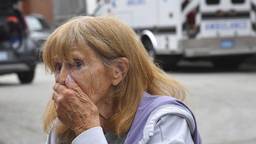 Donna Murphy, a resident at the Gabriel House assisted living facility, in Fall River, Mass., speaks with members of the media outside a temporary shelter, Monday, July 14, 2025, in Fall River, Mass., following a fire at the Gabriel House that started late Sunday and resulted in multiple fatalities. (AP Photo/Steven Senne)