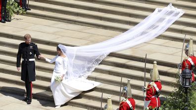 Meghan Markle and Britain's Prince Harry walk down the steps of St George's Chapel at Windsor Castle in Windsor, near London, England, following their wedding.