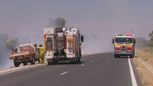 Residents of a rural Queensland town remain cut off from their community as a bushfire rages nearby.