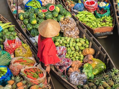 Woman selling on floating market in Vietnam