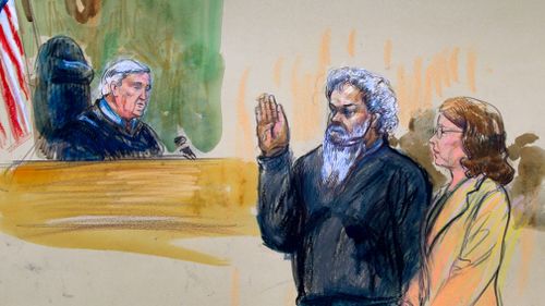 United States Magistrate, Judge John Facciola, swearing in the defendant, Libyan militant Ahmed Abu Khattala, wearing a headphone, as his attorney Michelle Peterson watches. (AP)