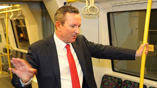 WA Premier Mark McGowan speaks to constituents on the train.