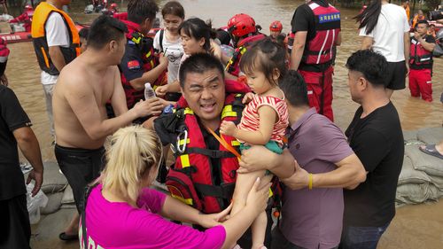 Rescuers using rubber boats evacuate trapped residents through floodwaters in Zhuozhou in northern China's Hebei province, south of Beijing, Wednesday, Aug. 2, 2023. China's capital has recorded its heaviest rainfall in at least 140 years over the past few days. Among the hardest hit areas is Zhuozhou, a small city that borders Beijing's southwest. (AP Photo/Andy Wong)