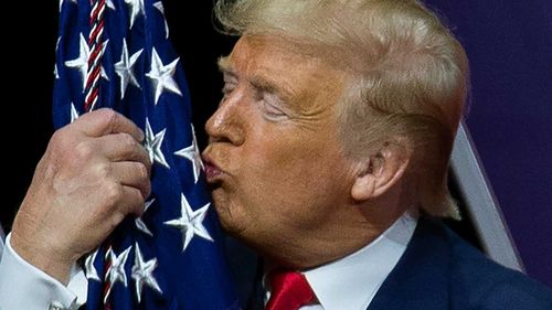 Donald Trump kisses the American flag at last year's CPAC.