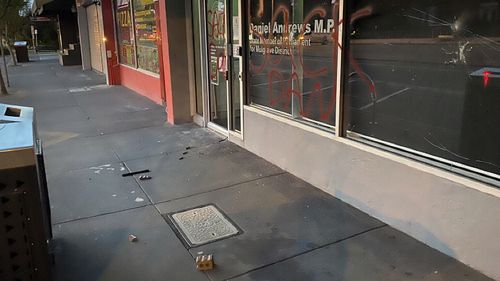 Victorian premier Daniel Andrews' office was attacked with graffiti- and a brick from an attempt to smash the window remains outside.