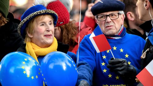 European Union supporters wait outside during the signing of a new Franco-German friendship treaty in Aachen, Germany.