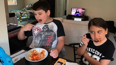 Boy with autism eating lasagne