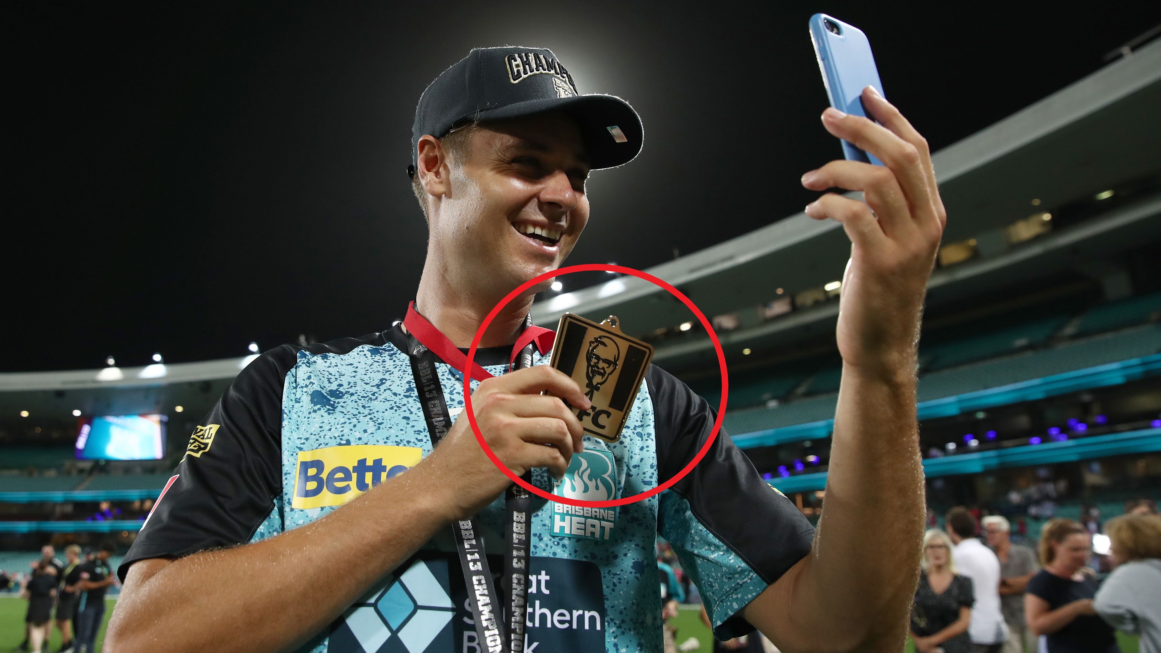 Brisbane Heat player Spencer Johnson shows off his KFC &#x27;player of the match&#x27; medal after the BBL final.