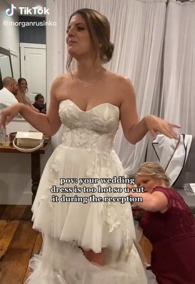bride cuts wedding dress due to heat