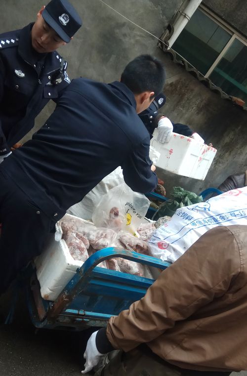 Police load a cart with items seized from a store suspected of selling trafficked wildlife are seen in Anji city in eastern China's Zhejiang Province.