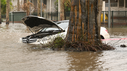 A car is inundated by floodwater on March 30, 2022 in Lismore, Australia as the Wilsons River rises.