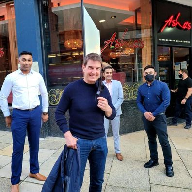 Tom Cruise with staff at Asha's restaurant in Birmingham, UK