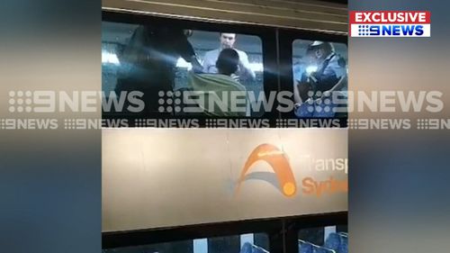 Officers boarded a train at Town Hall railway station around midday and arrested the man. (9NEWS)