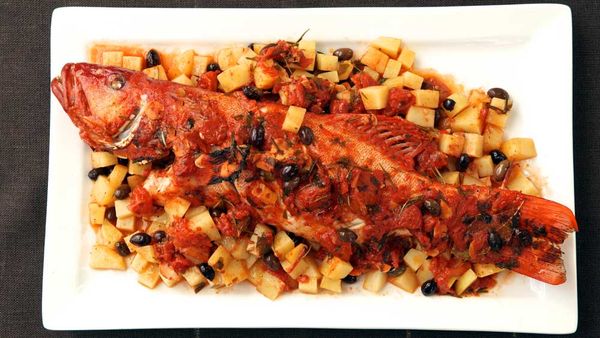 Baked whole coral trout with potato and tomato