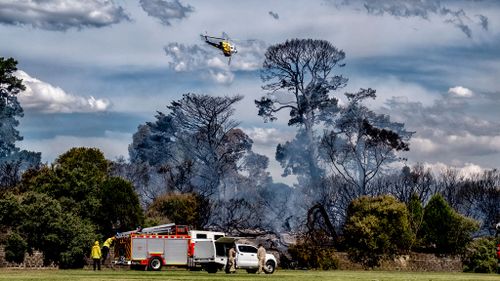 A water bomber helicopter is used to extinguish the fire. (Image: AAP)