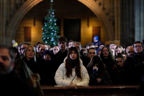 Mourners attend memorial service for the victims of Philosophical Faculty of Charles University shooting in the St. Vitus Cathedral in Prague, Czech Republic, Saturday, Dec. 23, 2023. 