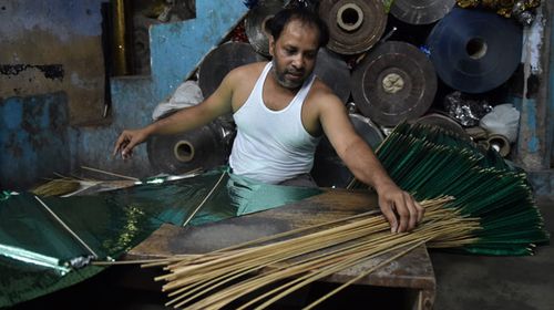 A kite maker in India. (AFP)