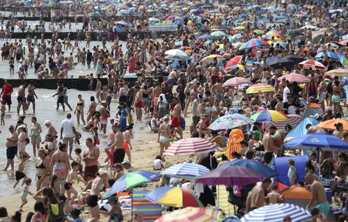 People in England enjoy the hot weather on Durley and Alum Chine beaches. England, last weekend.