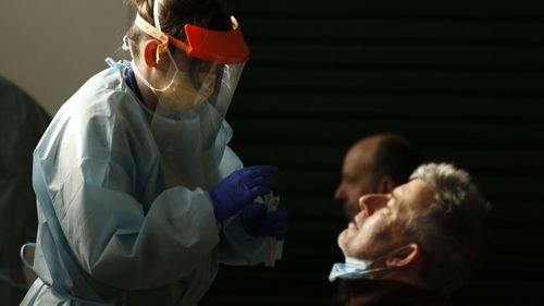 Members of the public are tested at a walk-in COVID clinic in Brunswick, Melbourne.