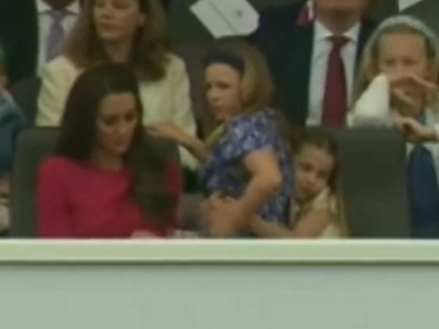 Princess Charlotte gives cousin Mia Tindall a squeeze during the Queen's Jubilee pageant parade.