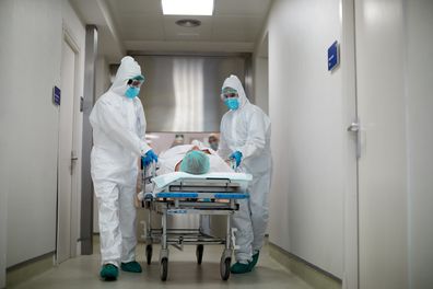 Hospital staff moving bed