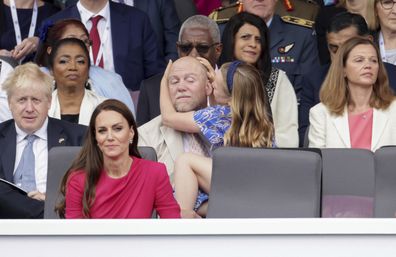 Mia Tindall rearranged her dad, Mike Tindall's very sparse haircut as they watch the Platinum Jubilee Pageant outside Buckingham Palace in London, Sunday June 5, 2022.